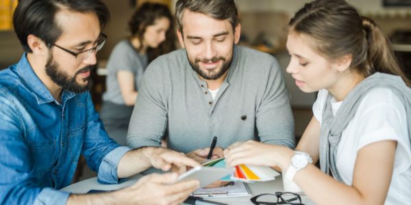 Group of professional designers choosing suitable colors from palette